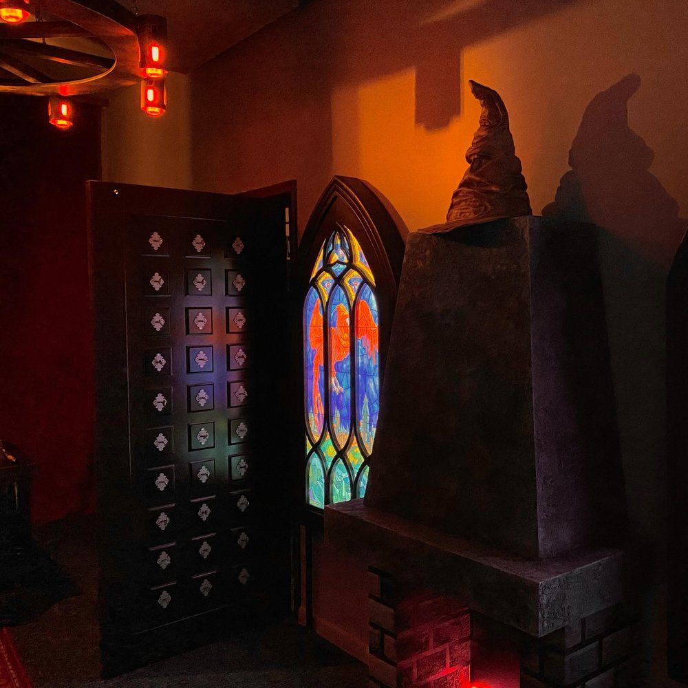 Inside the magic academy: a phoenix stained-glass window, a wizard’s hat and a chest of drawers – Return of the Sorcerer escape room, Warsaw